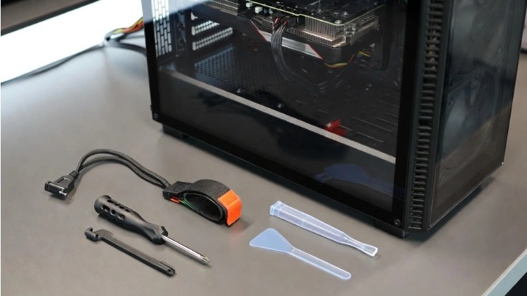 PC case opened with basic tools laid out on a desk, preparing for how to remove GPU safely without damaging hardware.